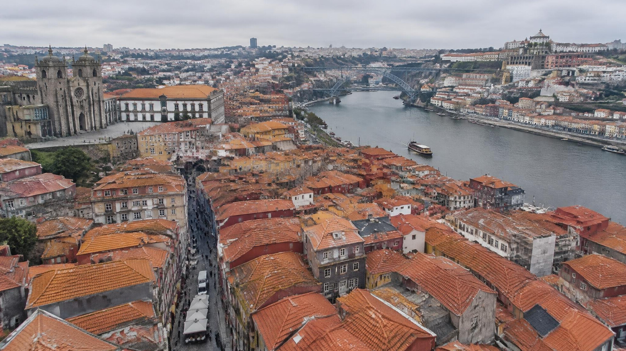 Aerial view of Porto city rooftops and infrastructure along the river
